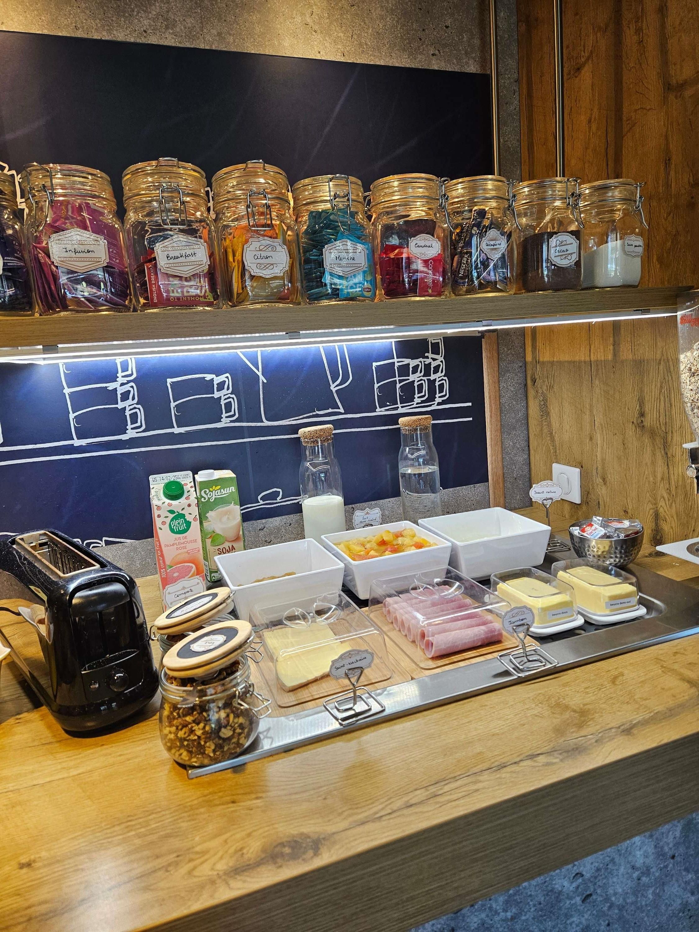 A breakfast bar with various food items and condiments.