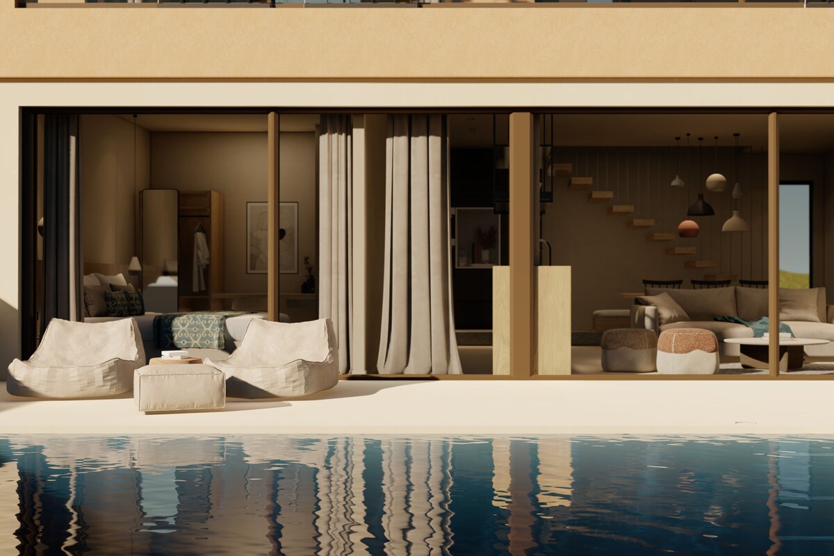 Un interior moderno con piscina, que presenta una sala de estar con sofás y un comedor con mesas.