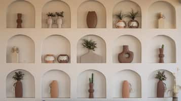 A wall with multiple arched niches containing various decorative items.