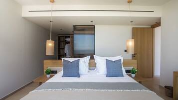 A modern hotel room with a large bed, two bedside tables, a nightstand, a small potted plant, and a wooden wardrobe.