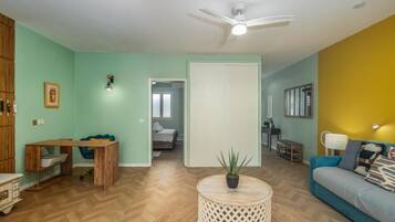 A living room with a wooden entertainment unit, a sofa, a coffee table, and a TV.