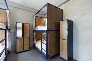 A compact room with bunk beds and built-in wardrobes, featuring a simple and functional design. - Arawana Hoft Hostel (Bangkok)
