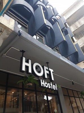 A hostel with a modern architectural design, featuring a prominent 'HOFT Hostel' sign above the entrance. - Arawana Hoft Hostel (Bangkok)