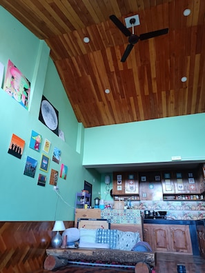 Relax in a stylish room with a comfortable bed, framed artworks, and a kitchen area.