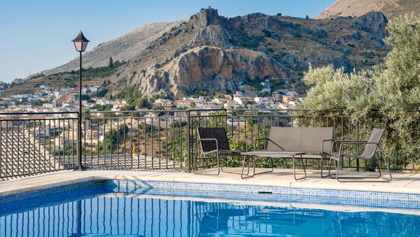 A swimming pool with lounge chairs, a lamp post, and a view of a town and mountains in the background. - Holiday Home 'Jabero' with Mountain Views, Wi-Fi and Air Conditioning (Nívar)