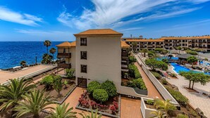 A coastal hotel with a swimming pool, a beach area, and a view of the ocean. - Vacation 'Atlantic 2 Amazing View' with Sea View, Shared Pool and Wi-Fi (Costa Del Silencio)