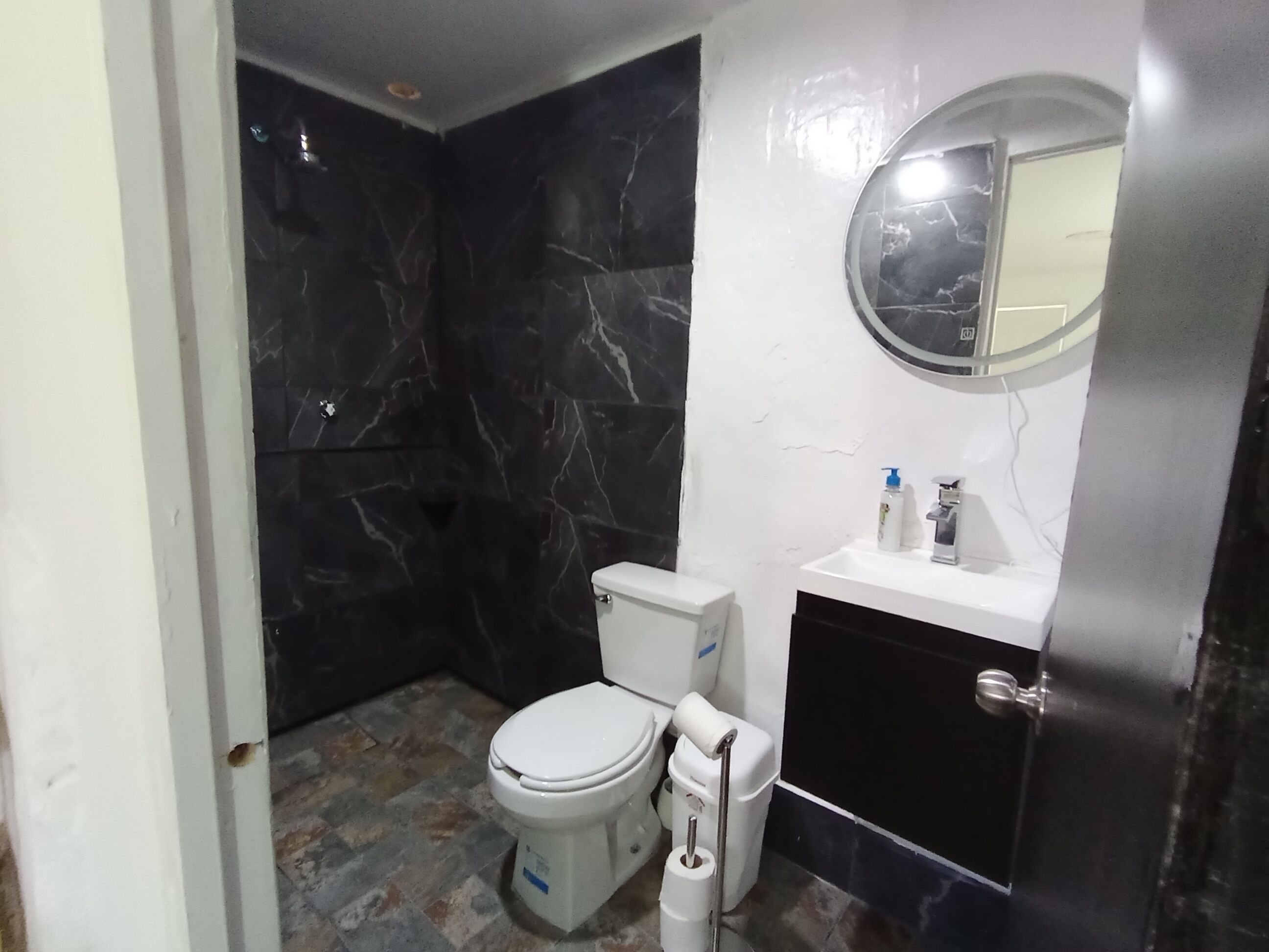 A bathroom with a toilet, bidet, and sink.