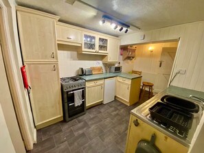 Enjoy cooking in this well-equipped kitchen with a gas stove, oven, and microwave.