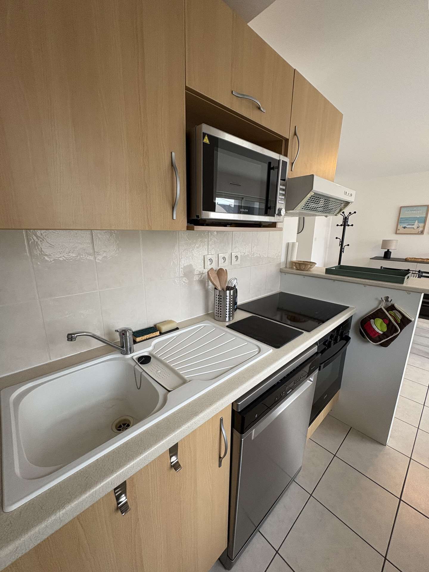 A modern kitchen with a stainless steel sink, a microwave, and a dishwasher.