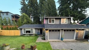 A two-story house with a garage, a front porch, and a well-maintained lawn. - Your Home in Sandy – Comfortable, Convenient & Affordable (Sandy)