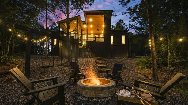 A cabin with a fire pit, outdoor seating, and string lights. - Back Deck with a View - Games - Pets - Hickory Pines (Broken Bow)