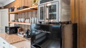 A kitchen with a stainless steel Frigidaire refrigerator, a built-in oven, and a microwave. - Chattanooga Cottage with Free Breakfast (Lookout Mountain)