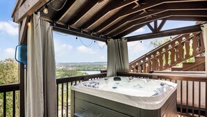 A hot tub on a wooden deck with a view of the landscape. - Historic Riverview Inn - King Room One (Chattanooga)