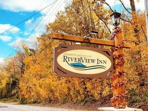 A sign for Riverview Inn with a mountain and river design.