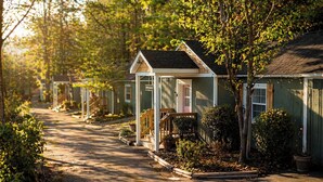 A row of small, single-story houses with front porches and a narrow driveway. - Lookout Mountain Cottage (Lookout Mountain)