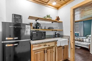 Fridge, microwave, coffee/tea maker, cookware/dishes/utensils