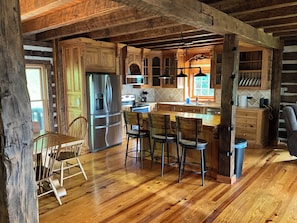 Enjoy cooking in this well-equipped kitchen with a large island, stainless steel appliances, and a sink.