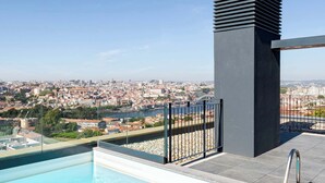 A rooftop pool with a clear view of a cityscape.