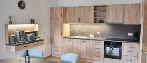Fridge, stovetop, dishwasher, coffee/tea maker