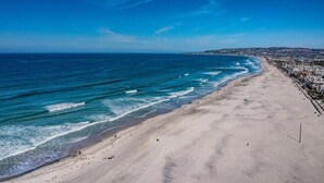 A beach with a clear view of the ocean and a distant cityscape. - Ocean Front * 2 Panoramic Water View Decks * A/C (San Diego)