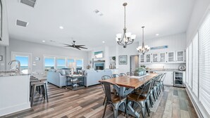 A spacious kitchen with a dining area, a large island, and a view of the ocean. - BEACHFRONT, BEAUTIFUL, FULLY RENOVATED HOUSE! (Gulf Shores)