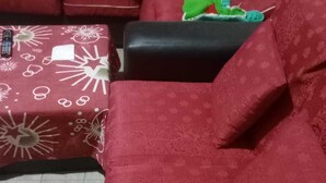 A living room with a red sofa, a black armchair, and a patterned ottoman. - Terrific 1-bedroom bed & breakfast in Cochabamba (Cochabamba)