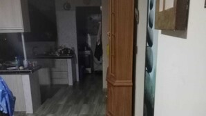 A narrow hallway with a wooden cabinet and a wall-mounted artwork. - Terrific 1-bedroom bed & breakfast in Cochabamba (Cochabamba)