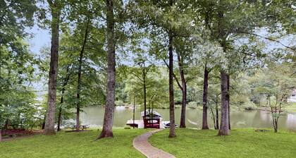 Spacious waterfront escape with screened porch, water slide, kayak, & games