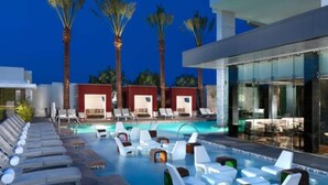 A pool area with lounge chairs and a bar area. - Resort in Las Vegas with NO RESORT FEES & FREE VALET SERVICE! (Las Vegas)