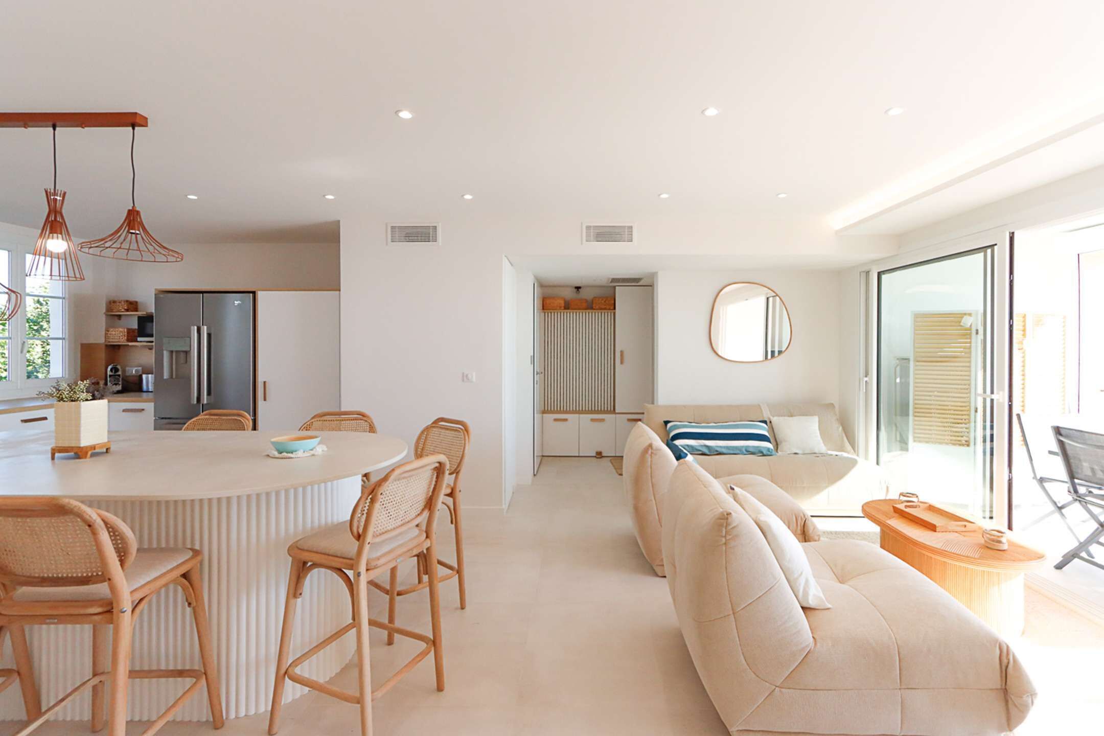 A modern living space with a kitchen, dining area, and seating area.