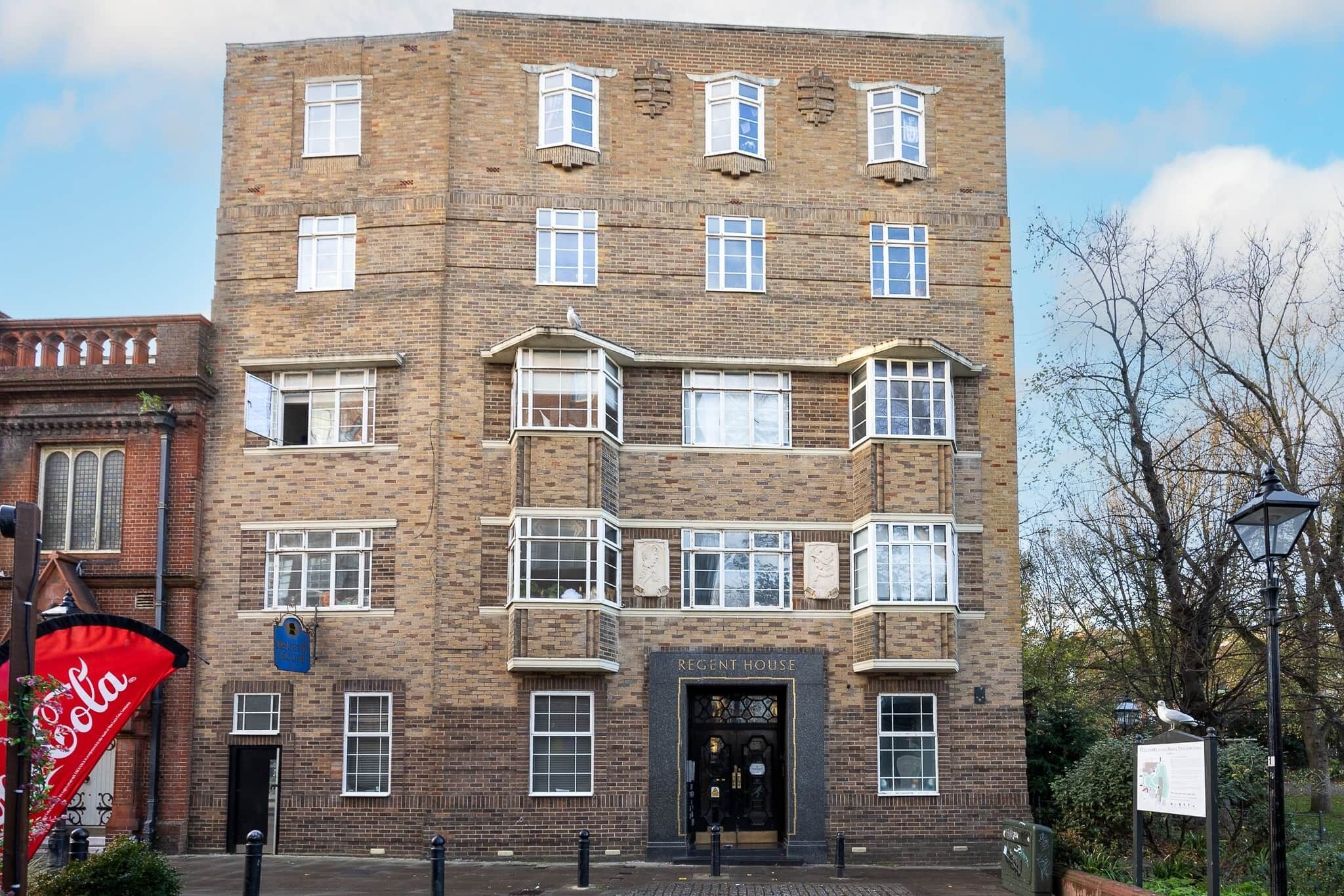 A multi-story brick building with a central entrance labeled "Regent House."