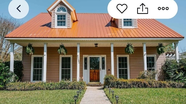 A two-story house with a red metal roof, a front porch with columns, and a small garage. - GameDay! University of South Alabama Poolside Getaway🇺🇲Veteran Own ⚓️ (Mobile)