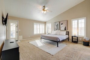 A bedroom with a bed, a desk, a ceiling fan, and artwork on the wall. - Private Pool: Group-Friendly Gilbert Getaway! (Gilbert)