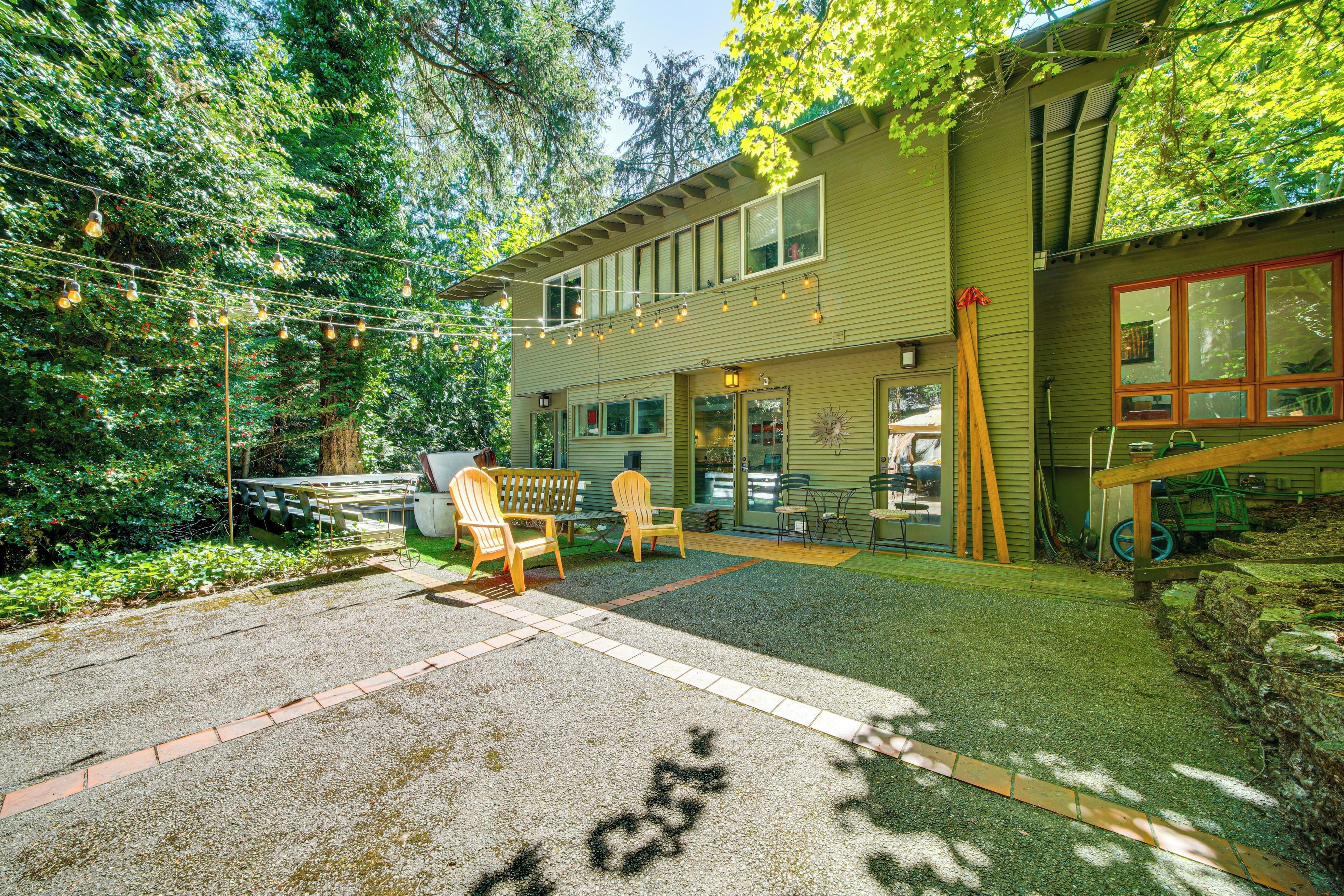 A house with a patio area, outdoor seating, and a wooden deck.