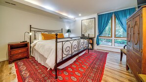 A bedroom with a bed, nightstand, dresser, and a large window with curtains. - 8 Mi to Dtwn Seattle: Pet-Friendly Apt w/ Hot Tub (Mercer Island)