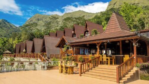 A wooden building with a balcony and a staircase leading to the entrance. - HK Villa's (Sembalunbumbung)