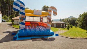 An inflatable bounce house with cartoon characters and candy cane decorations. - Apartment in Saales With Heated Pool (Saales)
