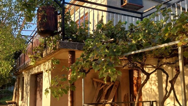 A building with a balcony, a wooden ladder, and a metal railing. - Holiday Home Marina - Two Bedroom Holiday Home with Terrace (Starigrad)