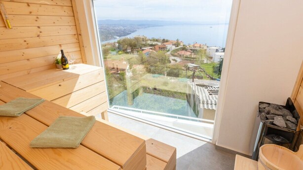 A wooden room with a large window overlooking a coastal town. - Apartments Bregha - One Bedrom Apartment with Terrace (Matulji)