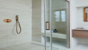 A modern bathroom with a glass shower enclosure, a wooden vanity, and a marble wall. - Elegant apartment - 3BR-8P- Le Marais (Paris)