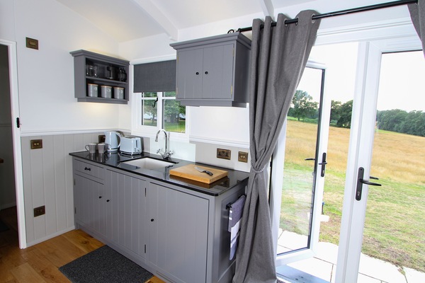 Entrance and kitchen with sink, twin hob, fridge, kettle, air fryer and toaster