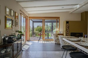 A modern kitchen with a dining area, large windows, and a view of the outdoors. - Poolside Grand Retreat Villa (Sveti Lovrec)