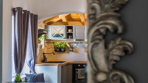 A kitchen with wooden cabinets, a sink, and a countertop with plants.