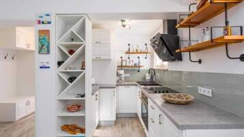 Cafetera o tetera, frigorífico, horno y placa de cocina