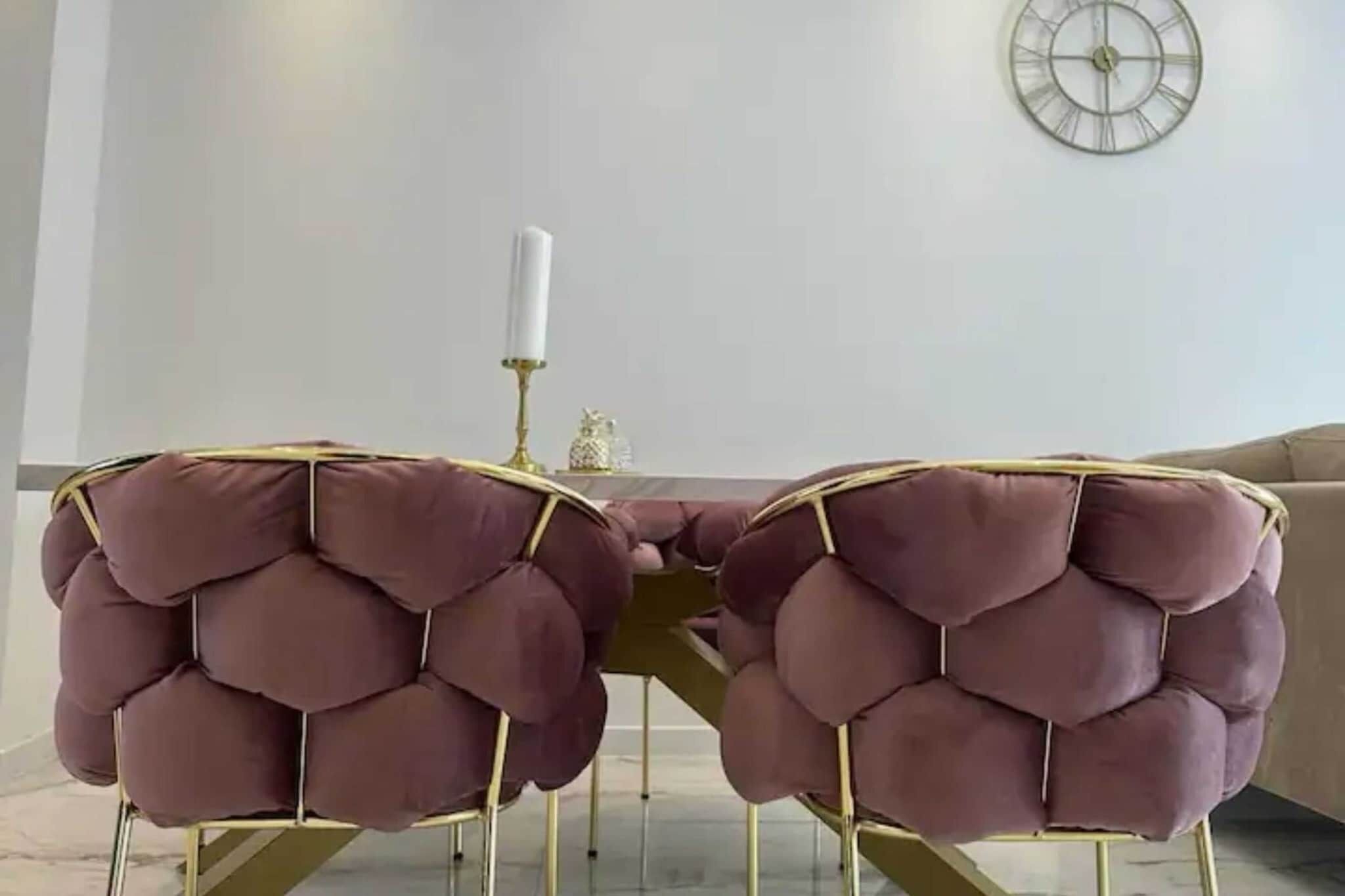 A dining area with a table and two chairs.