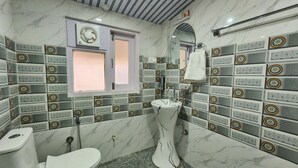 A bathroom with a toilet, sink, and a window. - The Kufri House (Theog)