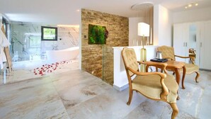 A modern bathroom with a large bathtub, a shower area, and a glass-enclosed toilet. There is a wooden wall with a green plant and a white cabinet with a mirror. - Wellness Villa- Four Bedroom Villa with Swimming pool (Grizane)