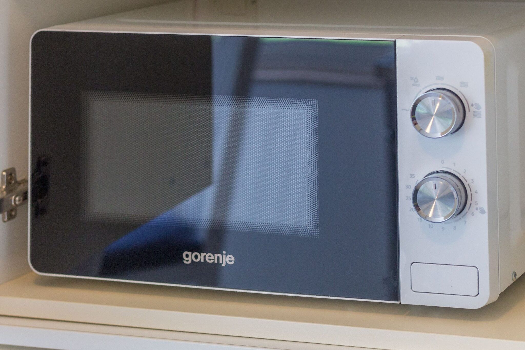 A microwave with two dials and a brand name 'gorenje' on the front.