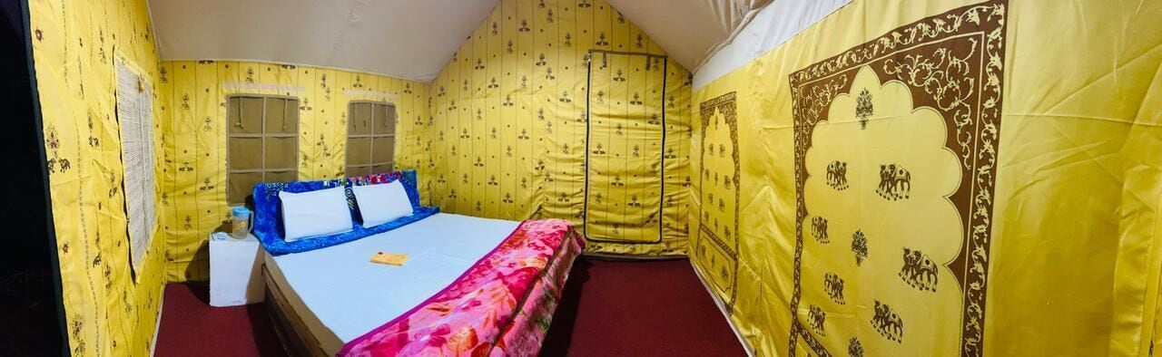 A small, yellow-themed room with a bed, a window, and a door.