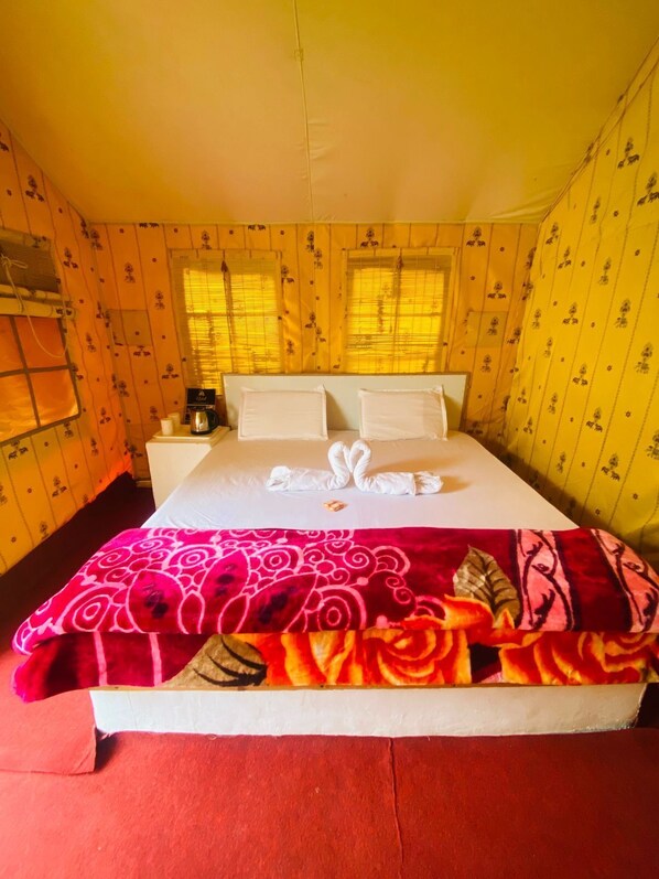 A hotel room with a bed, a nightstand, and a window with blinds. - Uphill Adventures and Meditation (Dharamshala)